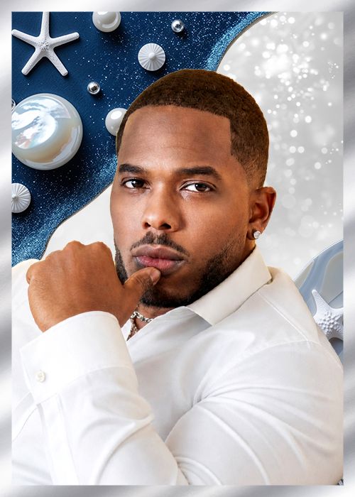 A man with a beard wearing a white shirt and looking thoughtful against a starry blue background with seashells.