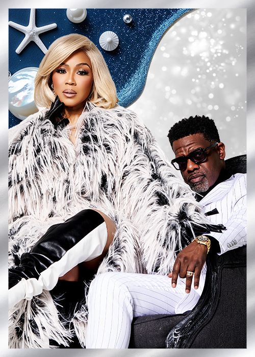 Two people wearing elaborate feathered and sequined outfits posing in front of a starry night backdrop with seashells and other marine elements.