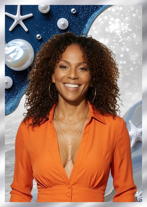 A smiling woman with curly brown hair wearing an orange shirt against a backdrop of starry blue and white shapes.